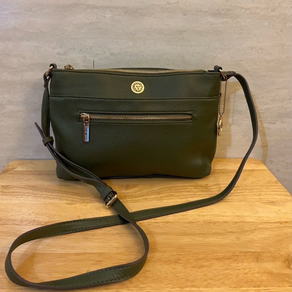 Anne Klein green crossbody bag with a gold lion logo.